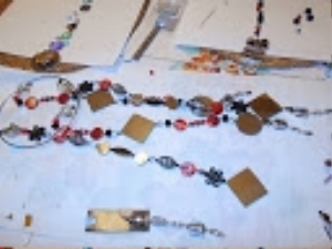 Work is well along. Dangles attached to rings and mirrors glued back to back in place